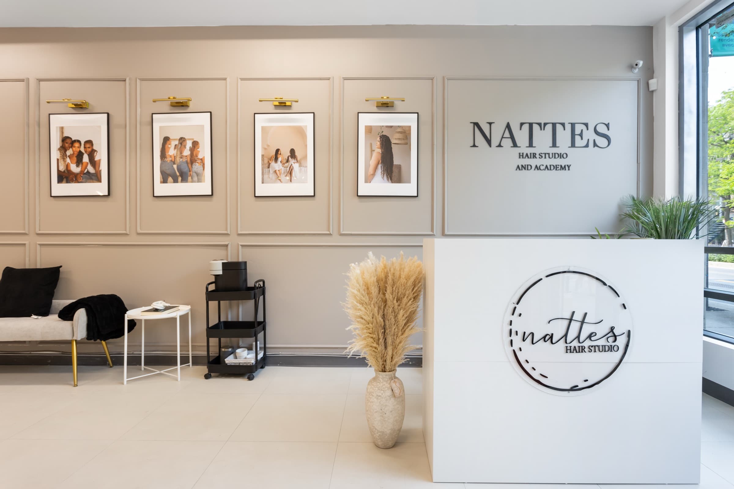 The reception desk and framed client photos at Nattes Hair Studio on Rue Saint-Denis