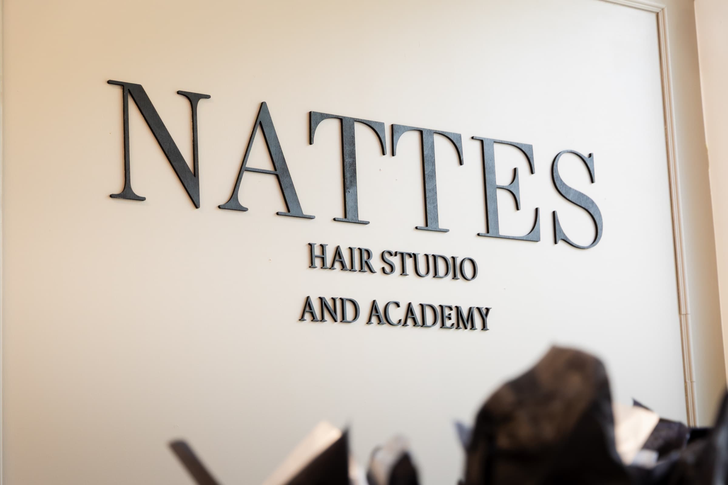 Nattes Hair Studio and Academy signage inside the Montreal studio