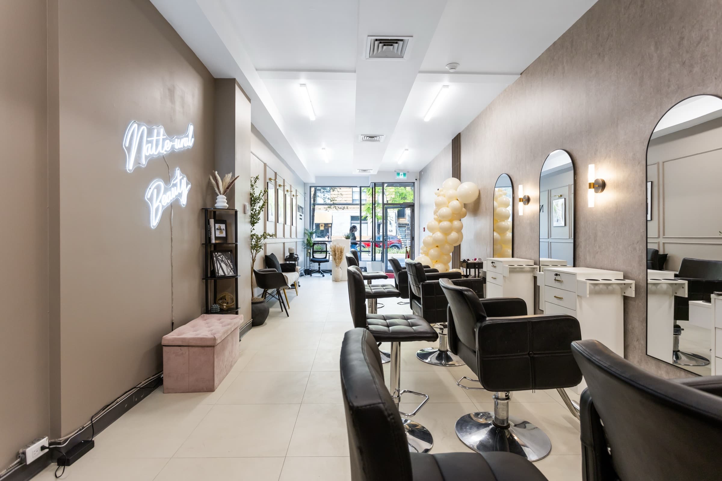 Styling stations, mirrors and salon chairs inside Nattes Hair Studio